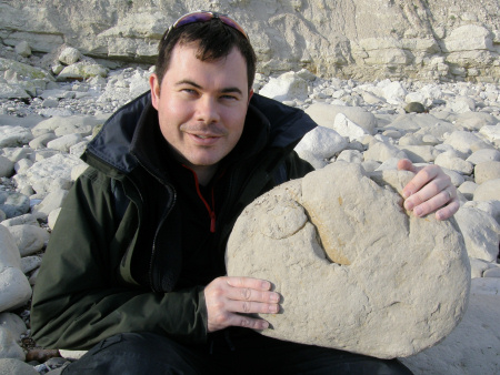 Roy Shepherd with chalk boulder containing the internal mould of a large ammonite shell