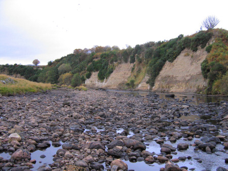 Loose boulders on the exposed river bed near Brora